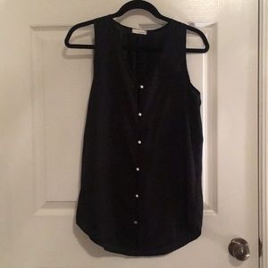 Black sheer blouse and it’s pearl buttons.